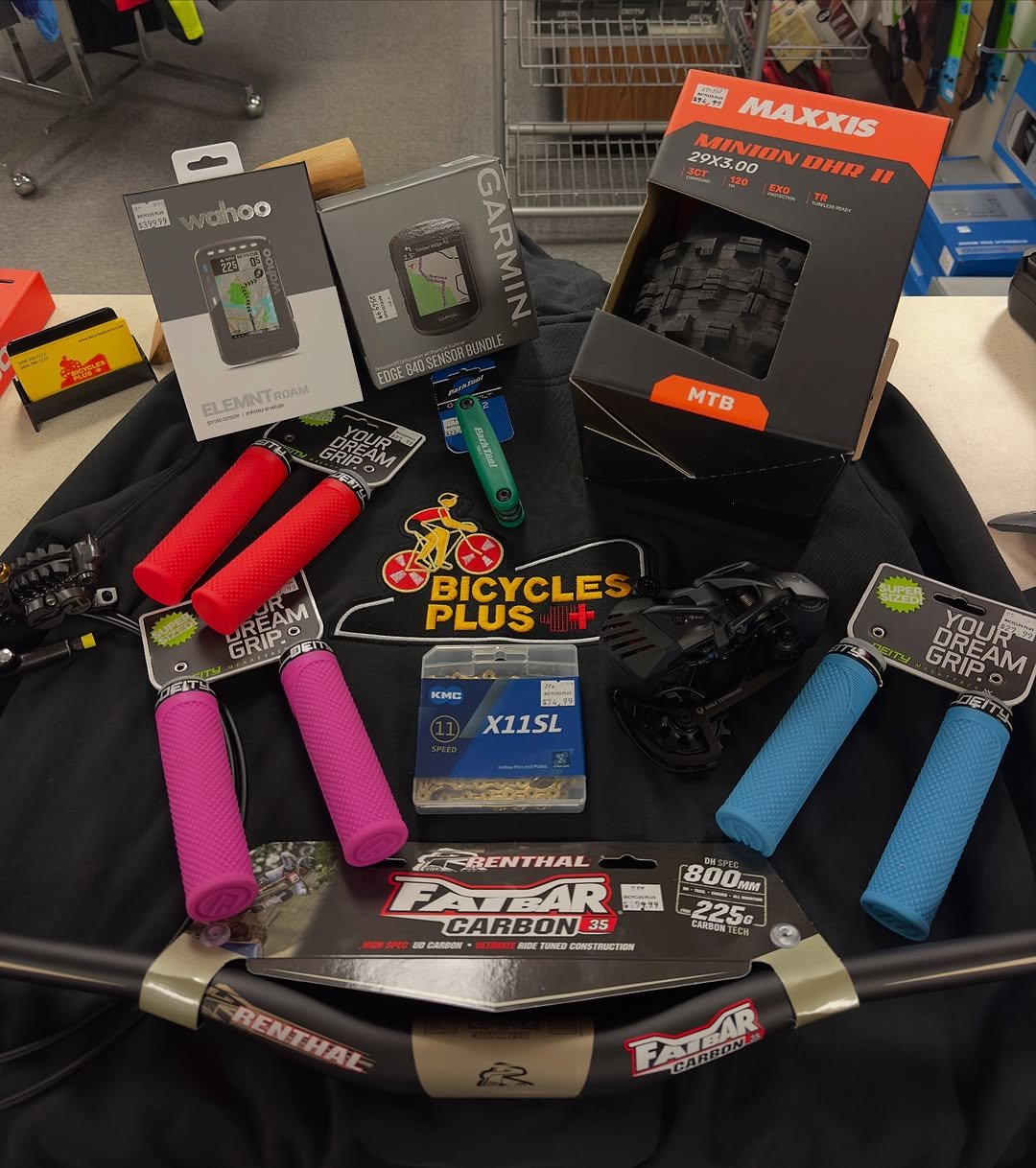 Bicycle grips, computer, chain, tire, derailleur, and handlebar arranged at Bicycles Plus